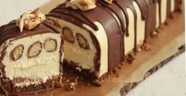 Une Bûche au Kinder Bueno garnie de crème onctueuse et décorée de morceaux de Kinder Bueno.