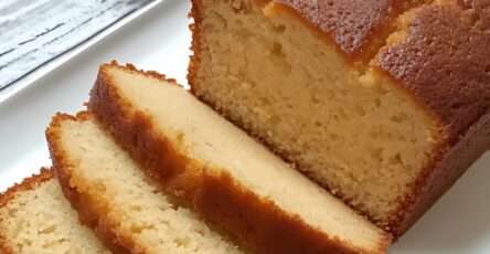 Barre bretonne dorée et moelleuse tranchée sur une assiette avec une tasse de thé