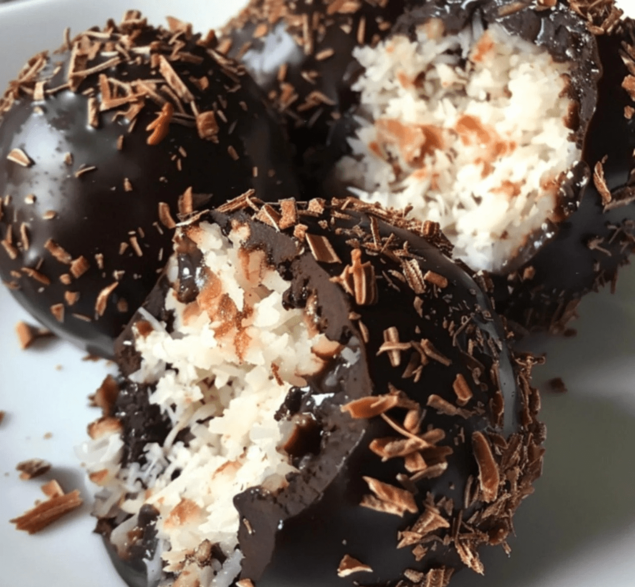 Boules de noix de coco enrobées de chocolat fondu disposées sur un plateau