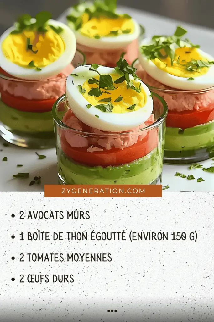 Verrines colorées avec avocat écrasé, thon, tomates et œufs durs garnies de ciboulette fraîche