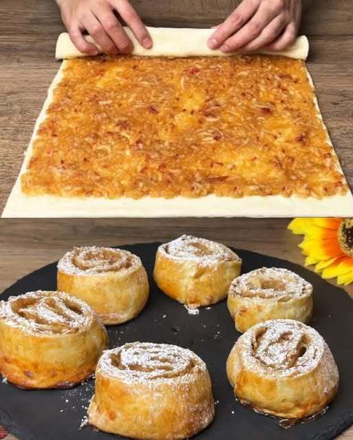 Roulés feuilletés aux pommes dorés et croustillants sur une assiette en céramique, garnis de sucre glace et servis avec une cuillère de crème fraîche.