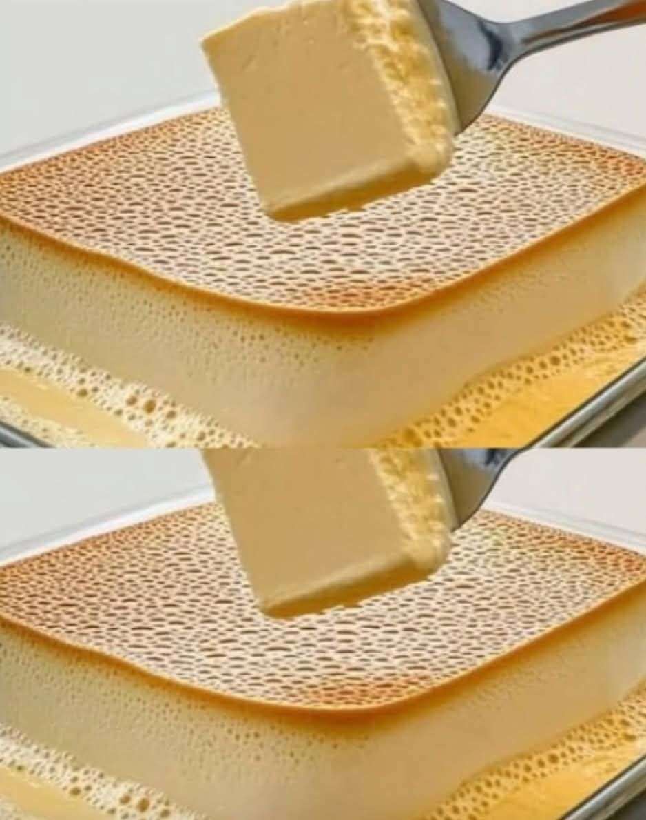 Tranche de flan maison moelleux, doré et lisse, servie sur une assiette avec cuillère