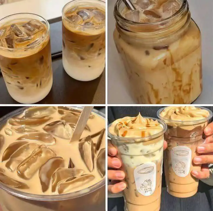 Vaso grande de café frío con leche y hielos en fondo de madera