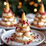 Dessert pyramidal composé de fines lamelles de poire superposées avec crème mascarpone, biscuits spéculoos et éclats de pistaches.