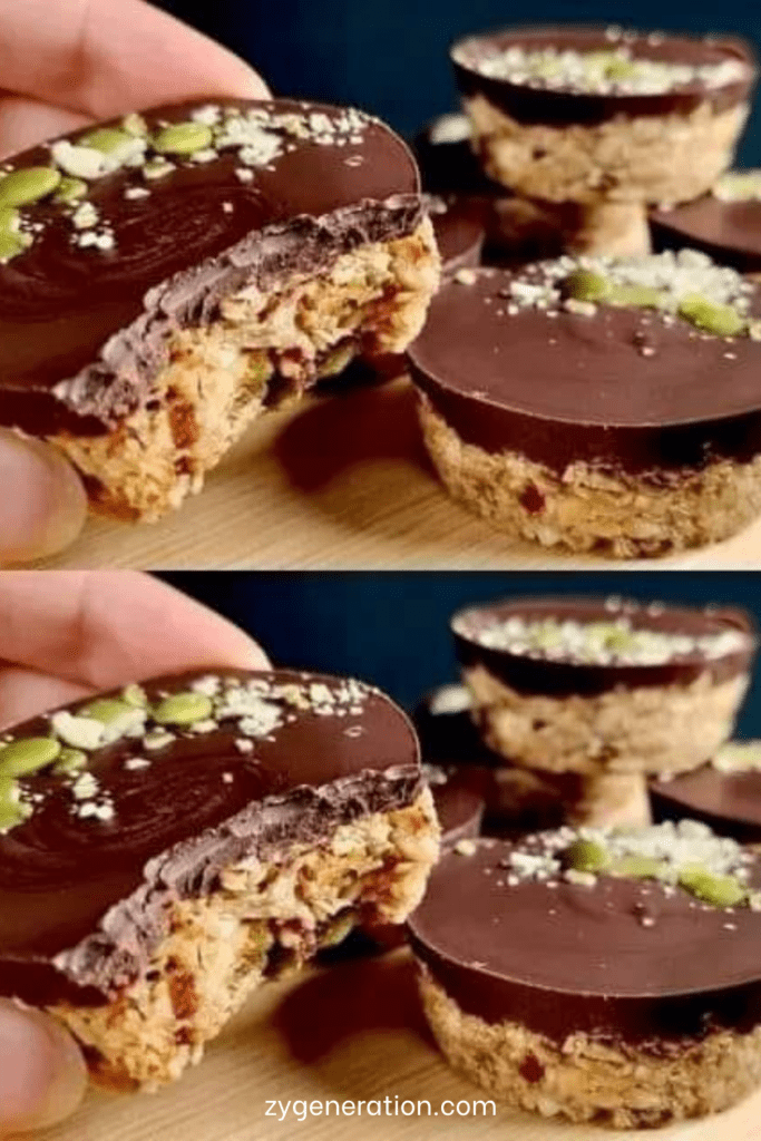 Barres énergétiques maison sans cuisson aux flocons d’avoine, dattes, graines et chocolat noir, découpées en portions régulières sur une surface en bois.