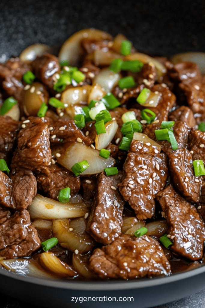 Sauté de bœuf aux oignons à la chinoise servi avec riz blanc, lamelles de bœuf tendres, sauce brillante, ail, oignons fondants et ciboule fraîche