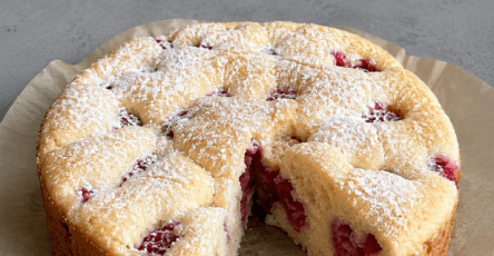 Gâteau moelleux citron framboise sans beurre, doré au four, avec une mie légère, des framboises visibles et un zeste de citron frais.